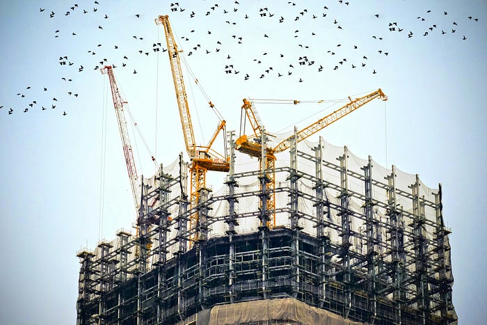 Photo by Danist Soh : https://unsplash.com/photos/low-angle-photography-of-cranes-on-top-of-building-8Gg2Ne_uTcM